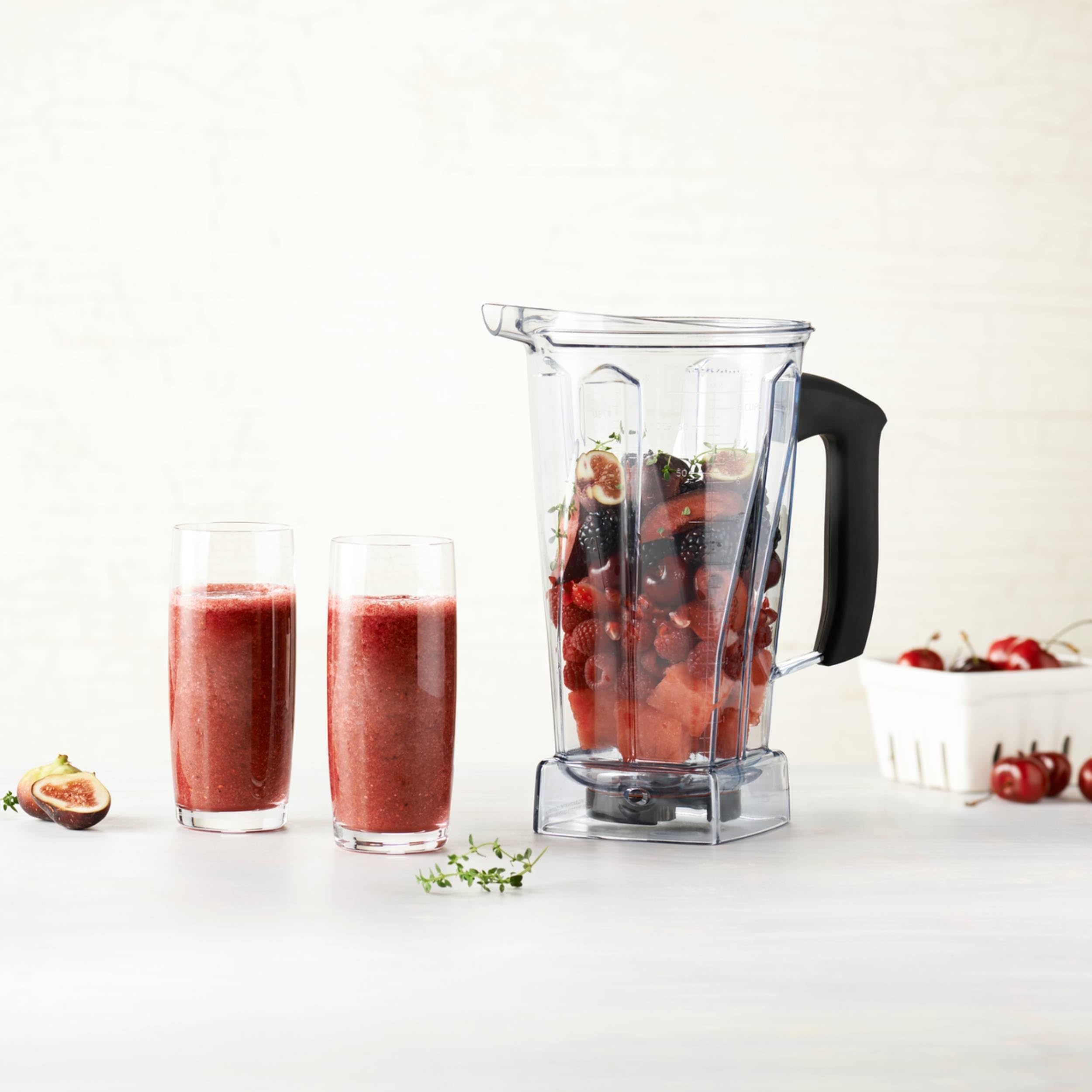 Vitamix Classic 64 oz container blending smoothie with lid plug removed to add ingredients easily
