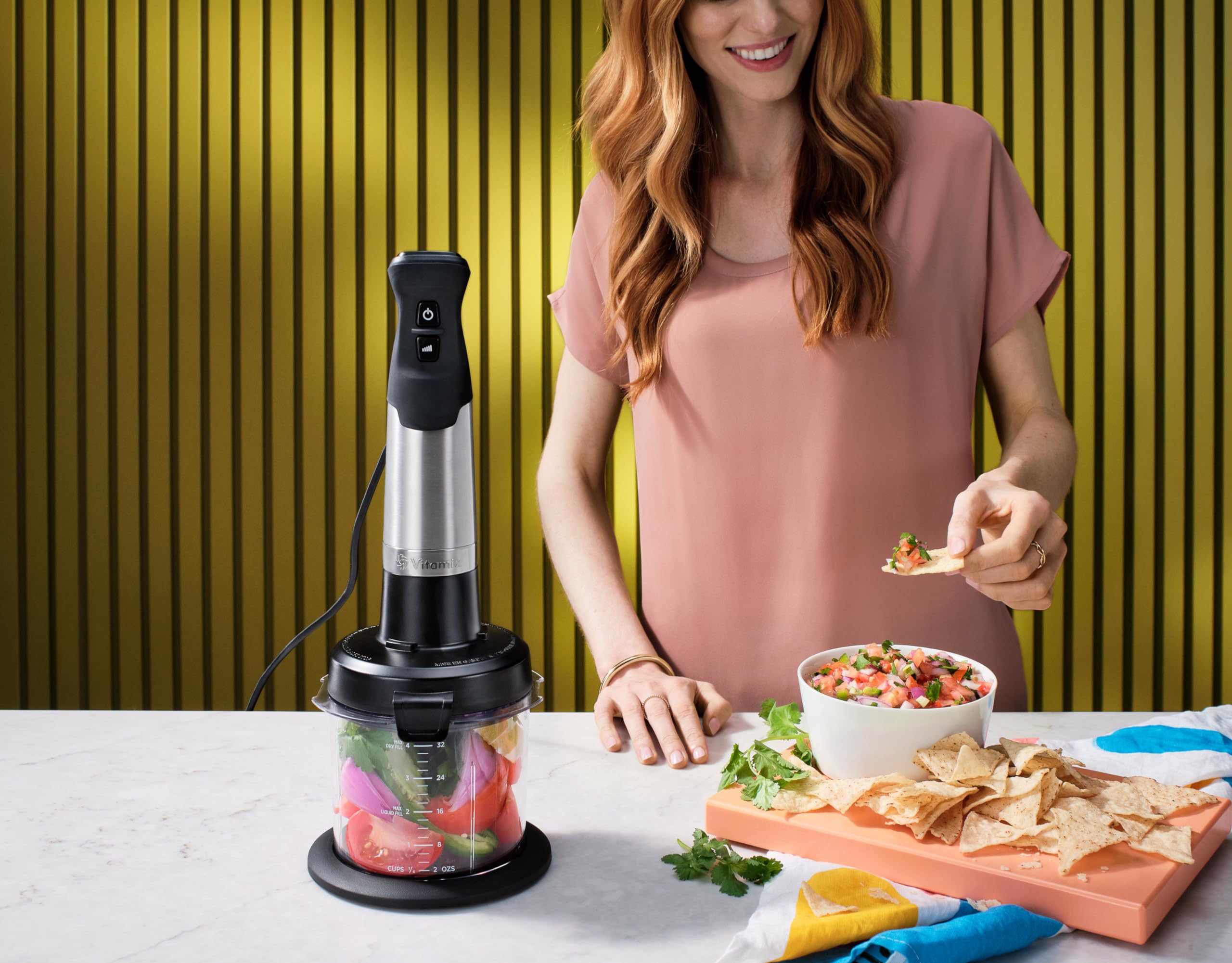 Vitamix mini-chopper next to measuring cup illustrating its 3-cup capacity