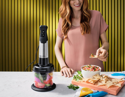 Vitamix mini-chopper next to measuring cup illustrating its 3-cup capacity