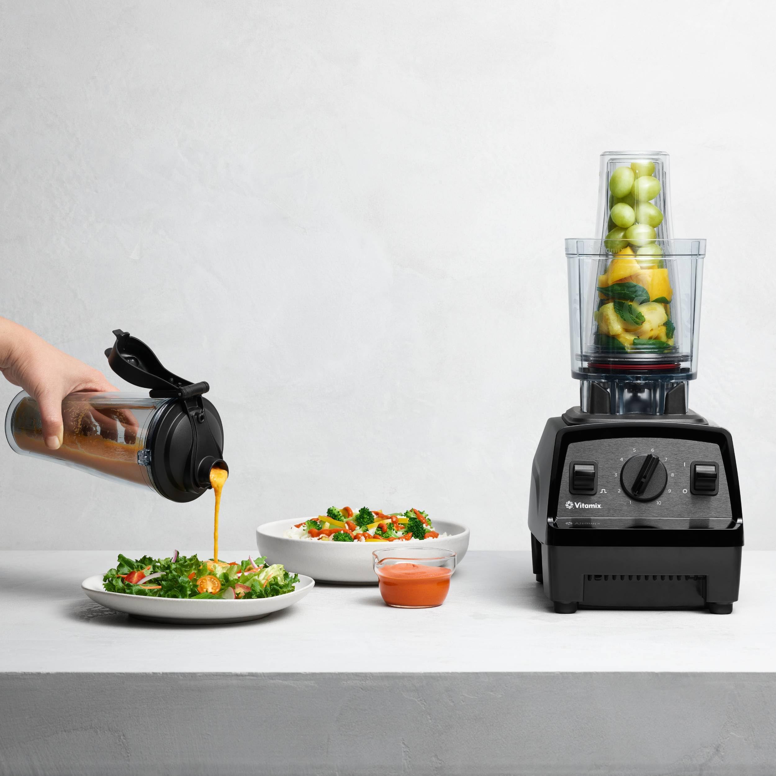 Vitamix cup next to full-size container illustrates compact single-serve size
