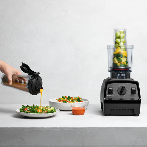 Vitamix cup next to full-size container illustrates compact single-serve size