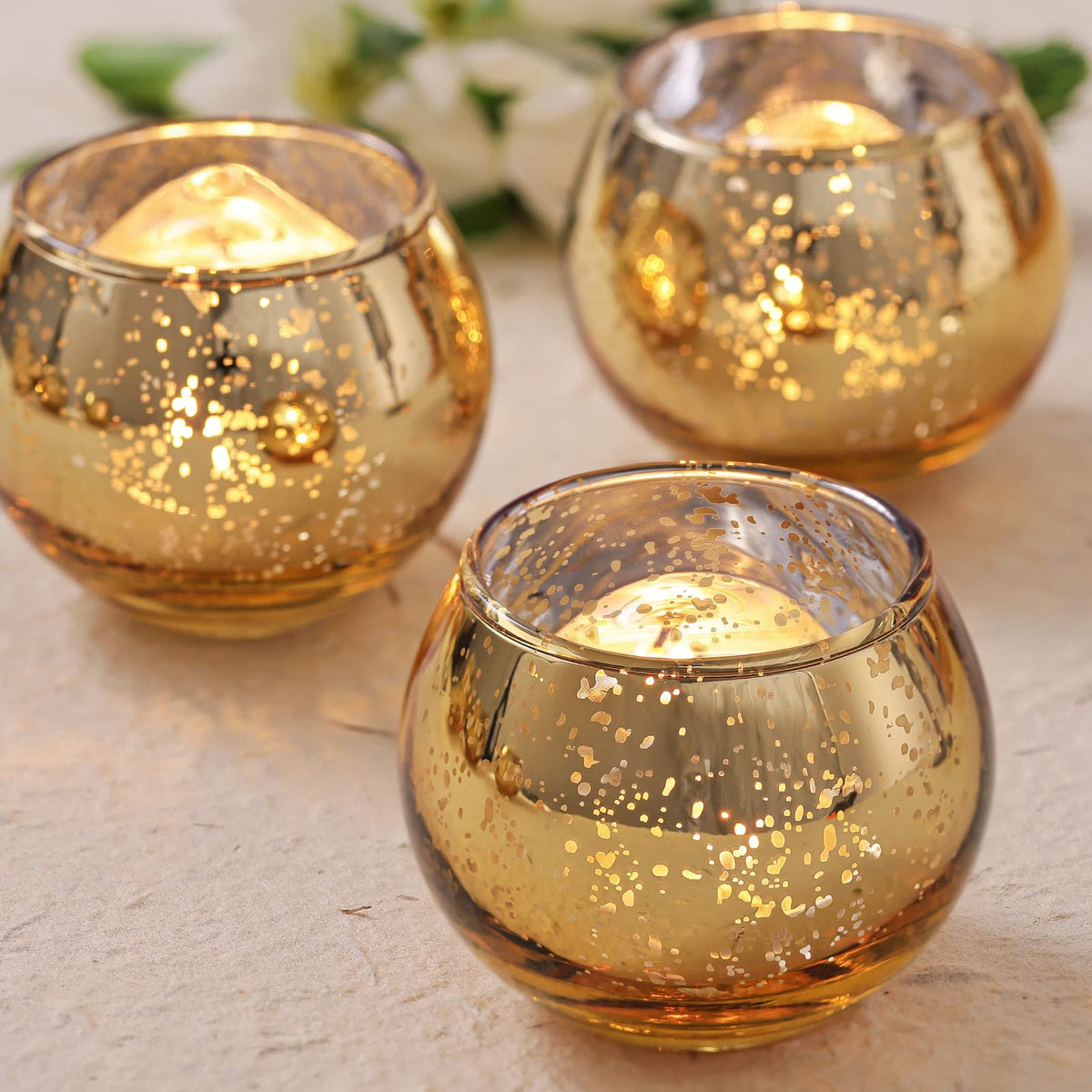 Volens front view of 24 gold votive holders showing elegant set and unified finish