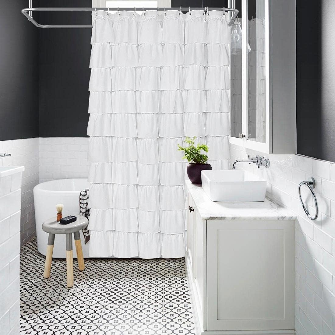 Volens shower curtain hung in styled bathroom creating cozy, elegant ambiance