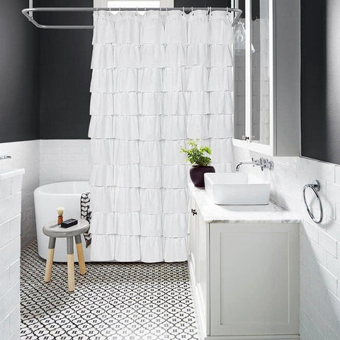 Volens shower curtain hung in styled bathroom creating cozy, elegant ambiance