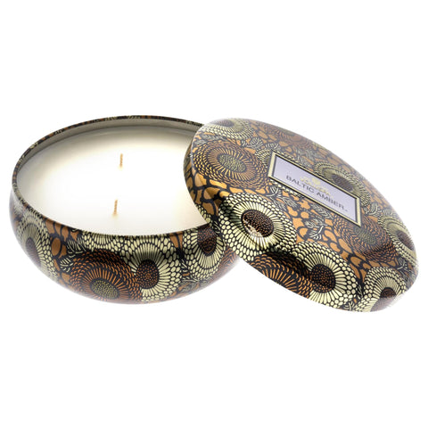 Voluspa Baltic Amber candle styled on a living room shelf adding warm ambiance