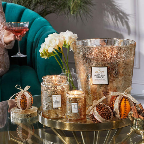 Voluspa candle on a coffee table in living room creating ambient fragrance and aesthetic appeal