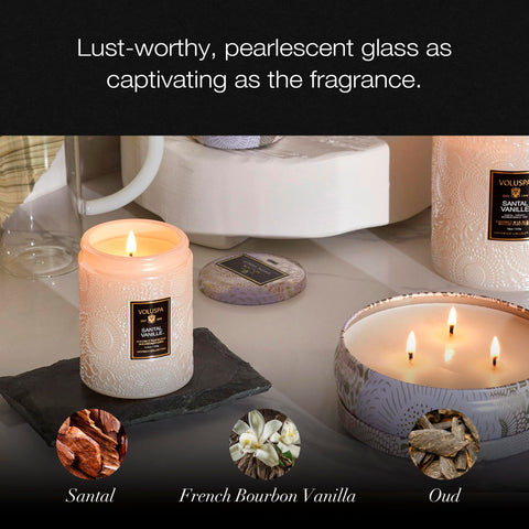 Voluspa candle burning in a cozy room benefit: warm ambient fragrance