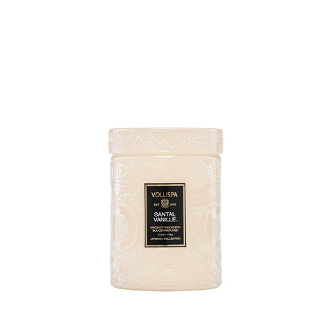 Voluspa Santal Vanille front jar showing white glass and candle glow benefit: elegant décor