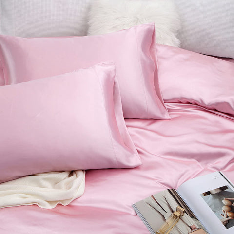 Vonty styled bedroom with pink satin sheets creating an upscale, cozy atmosphere