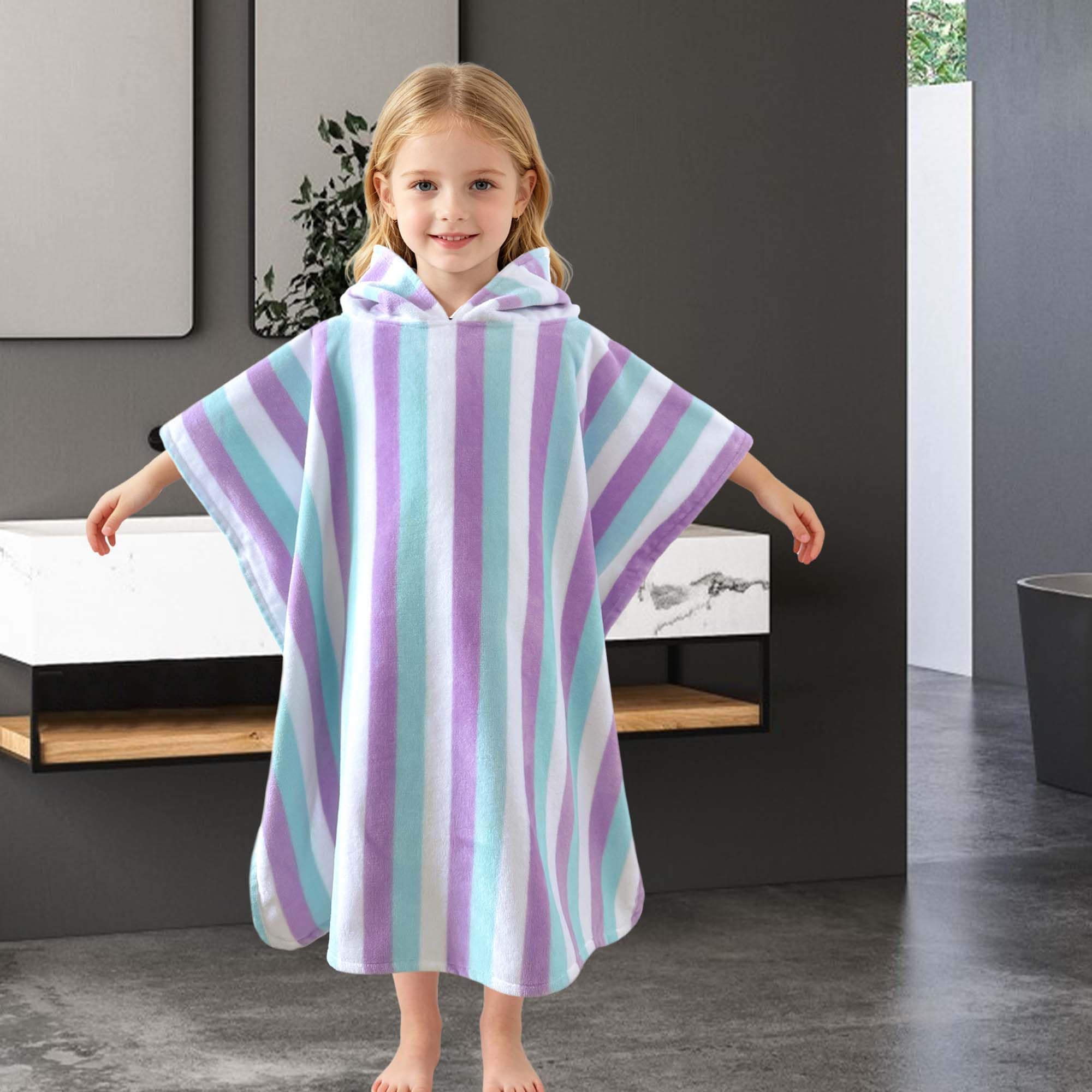 VOOVA & MOVAS child wearing poncho at beach for easy dry-off benefit