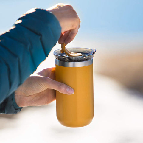 Hand holding WACACO Octaroma Lungo demonstrating comfortable grip and sipping convenience