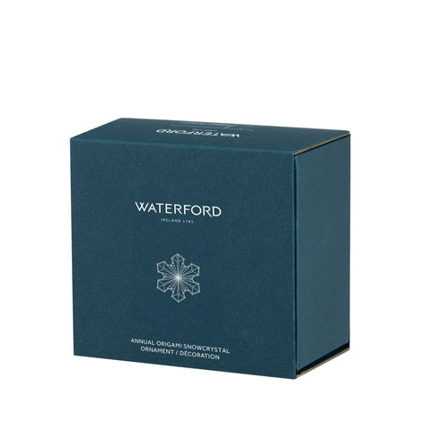 Waterford ornament hanging on a Christmas tree creating radiant reflections and ambiance