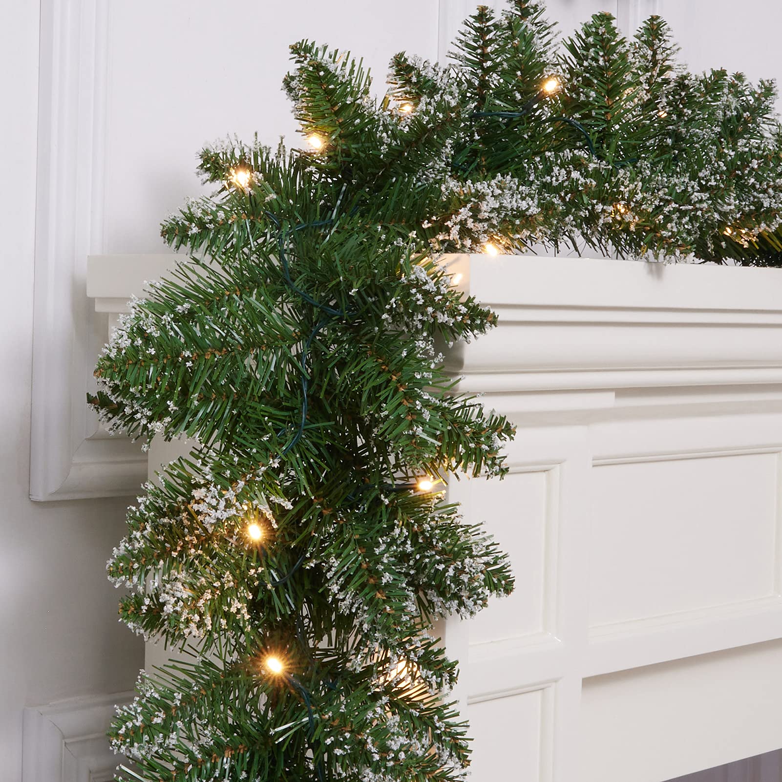 WBHome garland draped on staircase adding elegant holiday charm
