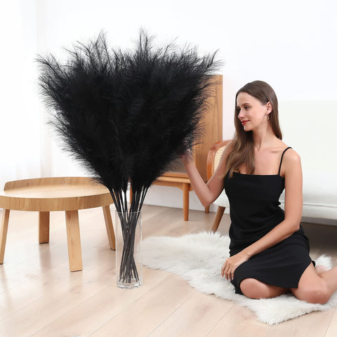 Wertuirk styled in a tall vase in a living room adding vertical drama