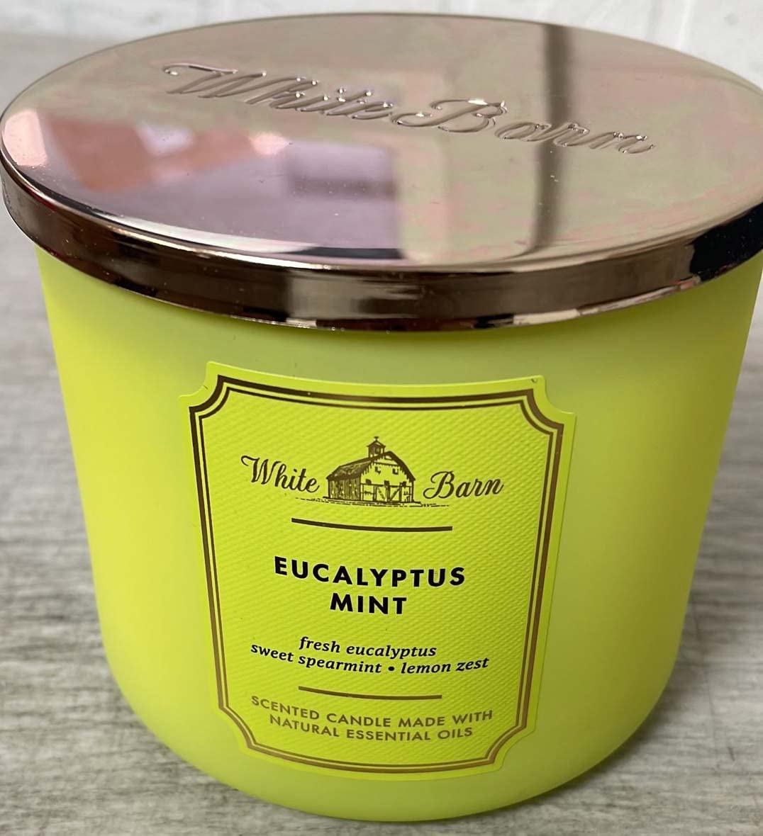 White Barn eucalyptus mint candle lit in a living room, creates fresh relaxing ambiance