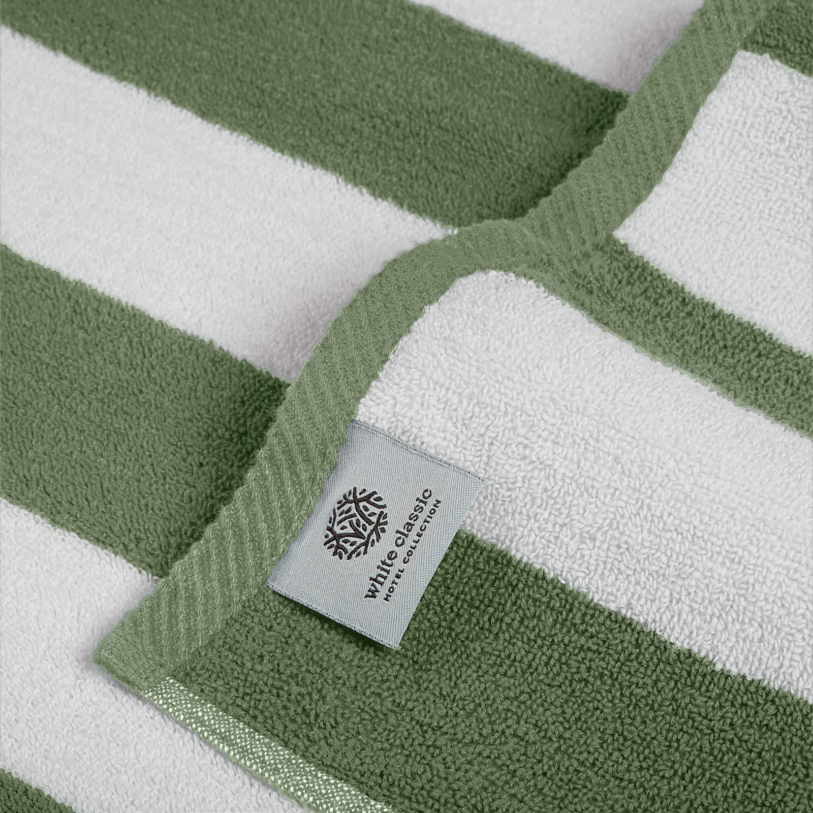 White Classic towel spread on sand with person lounging showing comfort and portability