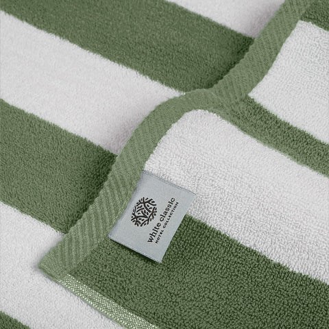 White Classic towel spread on sand with person lounging showing comfort and portability