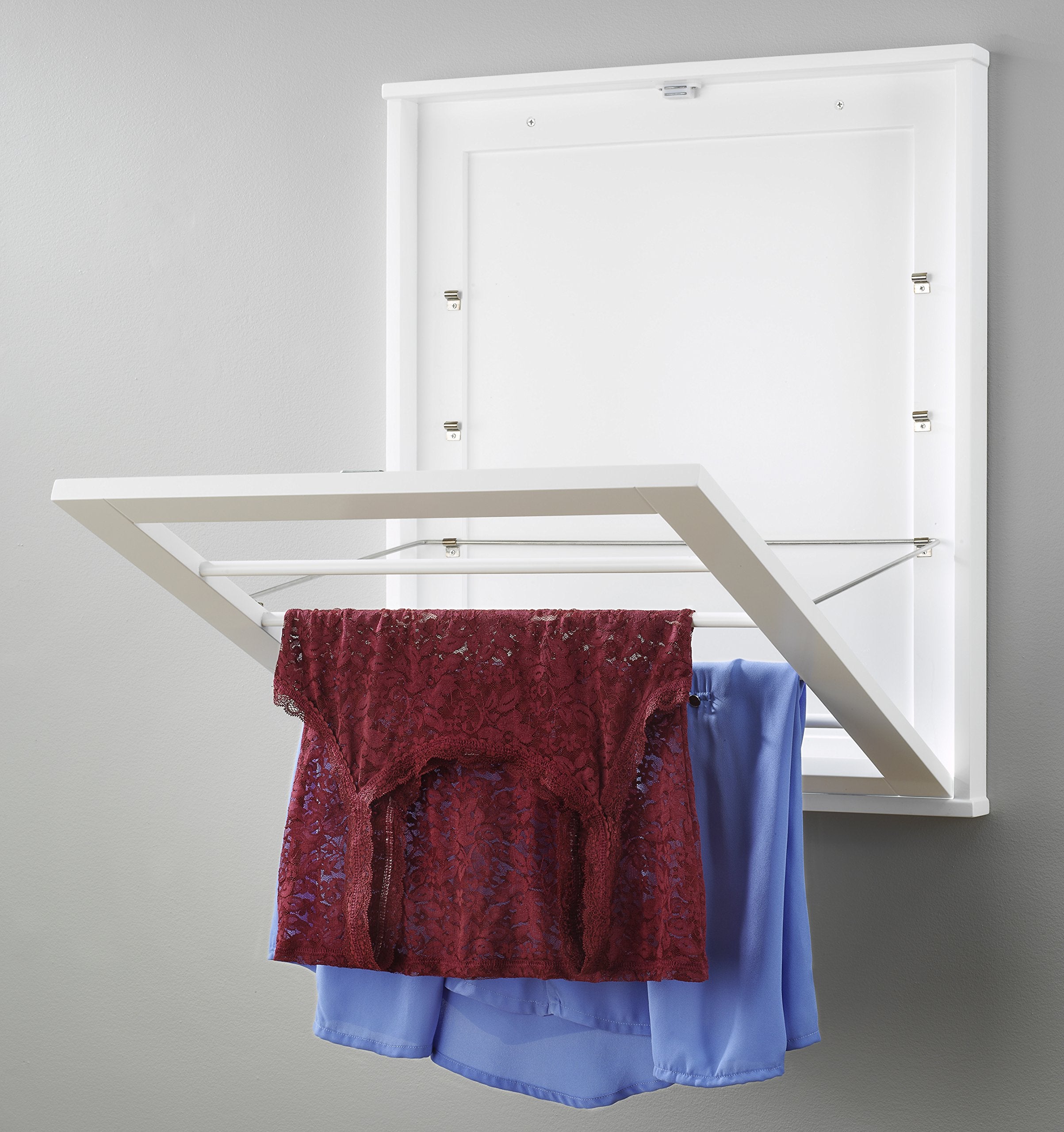 Whitmor folded flat against wall demonstrating compact storage advantage