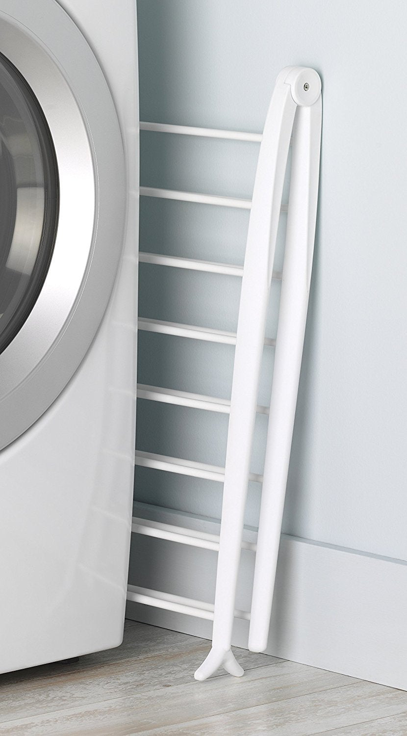 Whitmor Spacemaker folded flat stored beside washer showing compact storage benefit