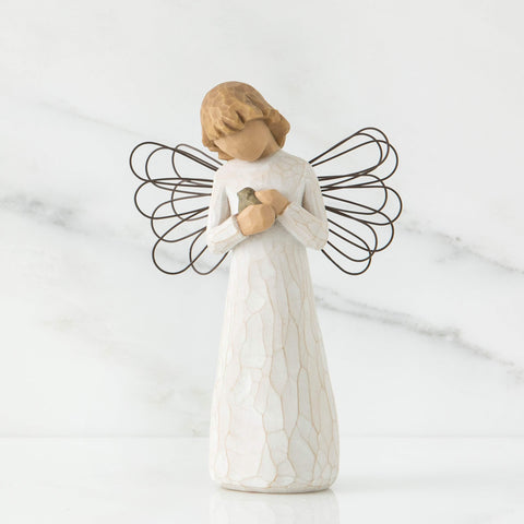 Willow Tree close-up of angel holding blue-gray bird highlights delicate detail and hope