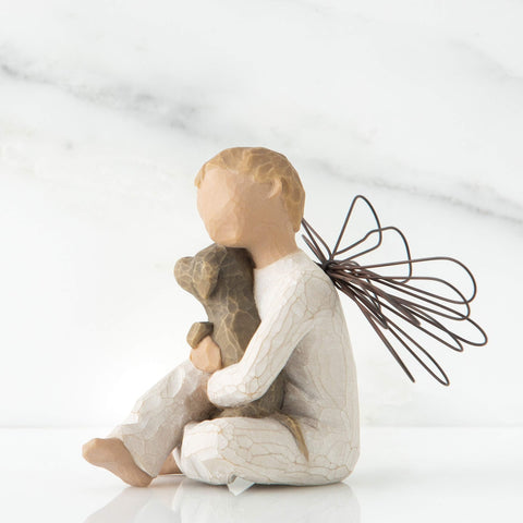 Willow Tree detail of seated boy angel holding brown dog, evokes tenderness