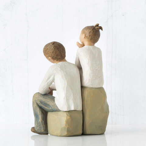 Willow Tree scale shot in an adult's hands showing compact size and gift-ready charm