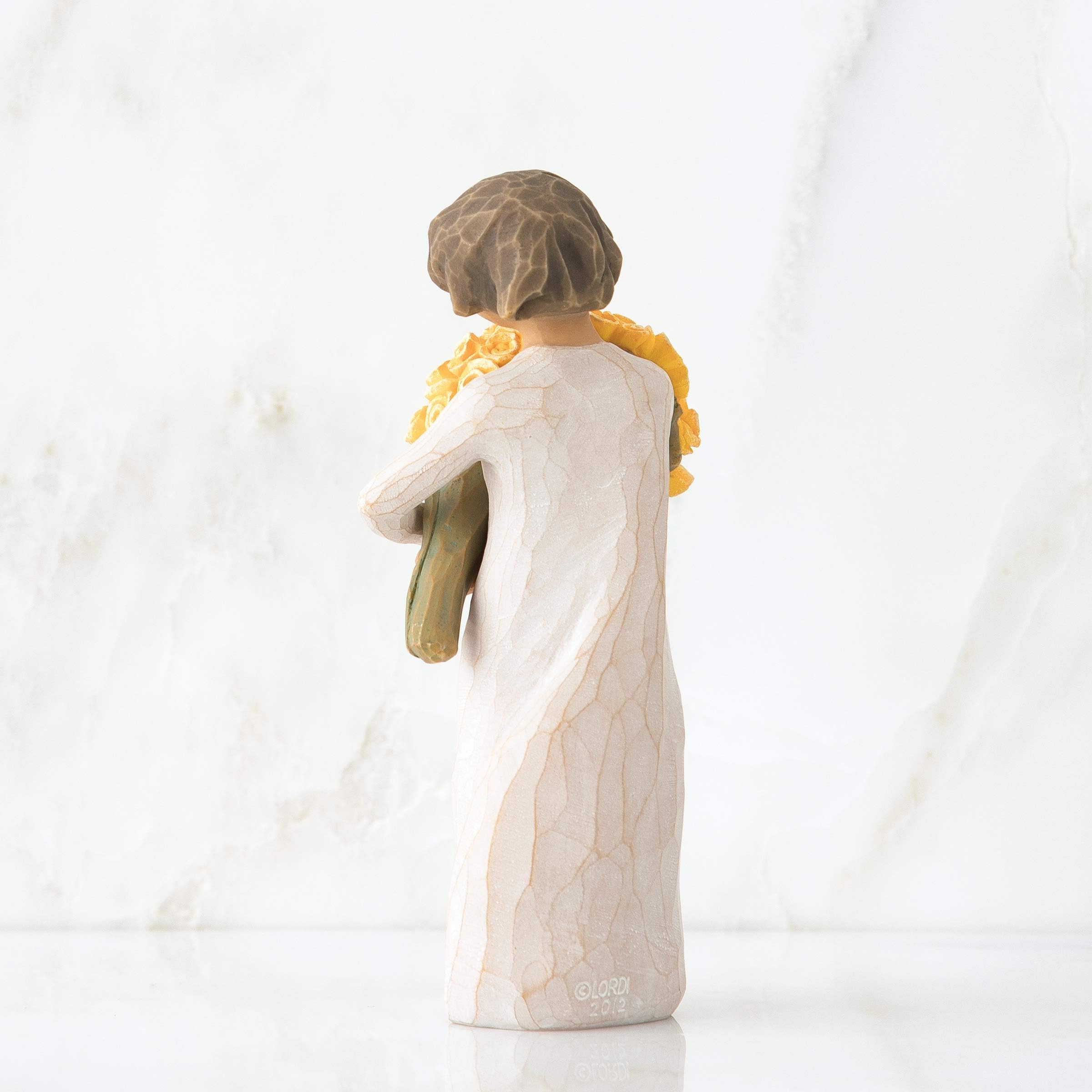 Willow Tree shown beside a hand to demonstrate 5.5-inch scale and portability