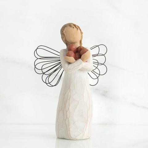 Willow Tree red apples detail on figure offering a cheerful symbolic accent