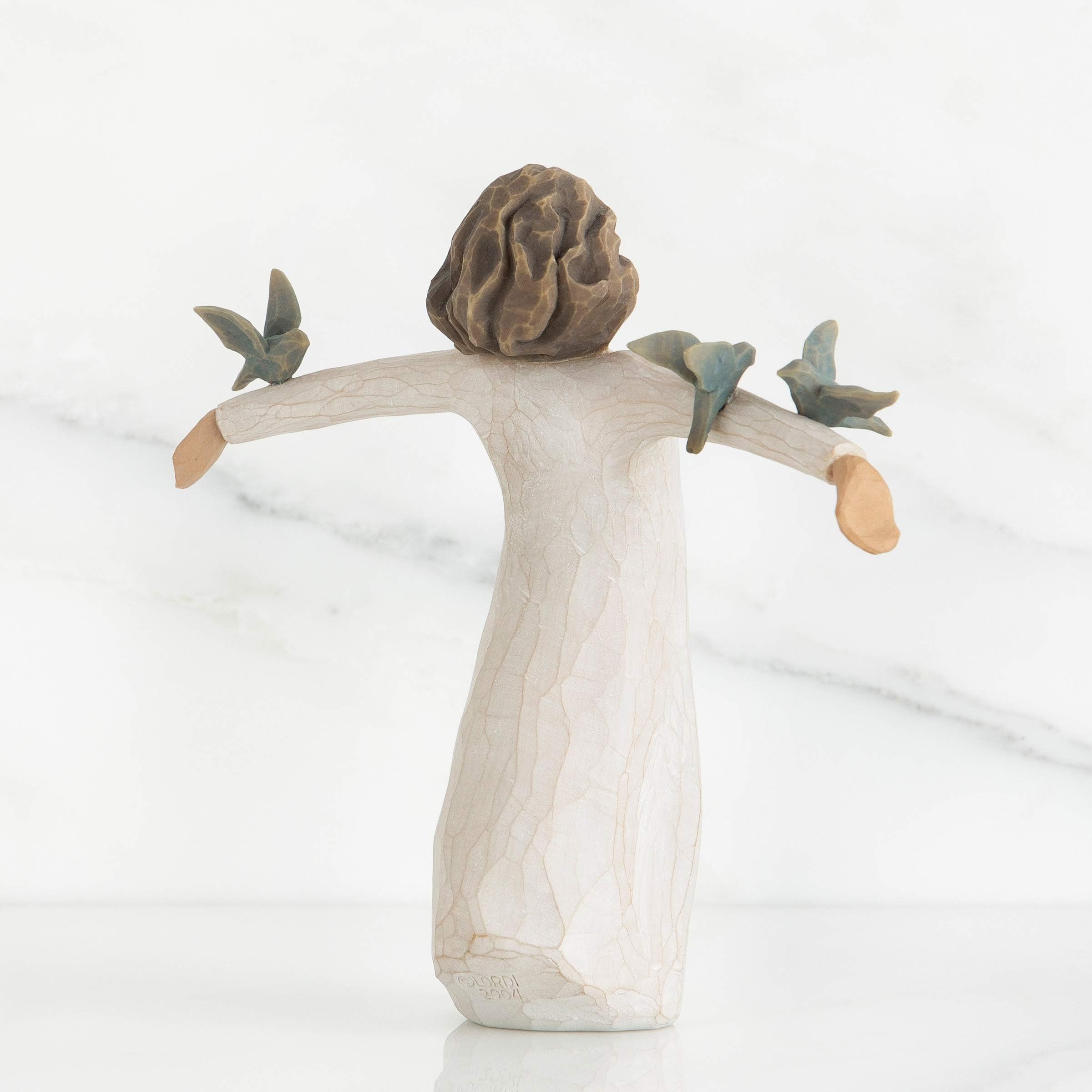 Willow Tree side profile showing dress texture and carving, emphasizes artisanal finish