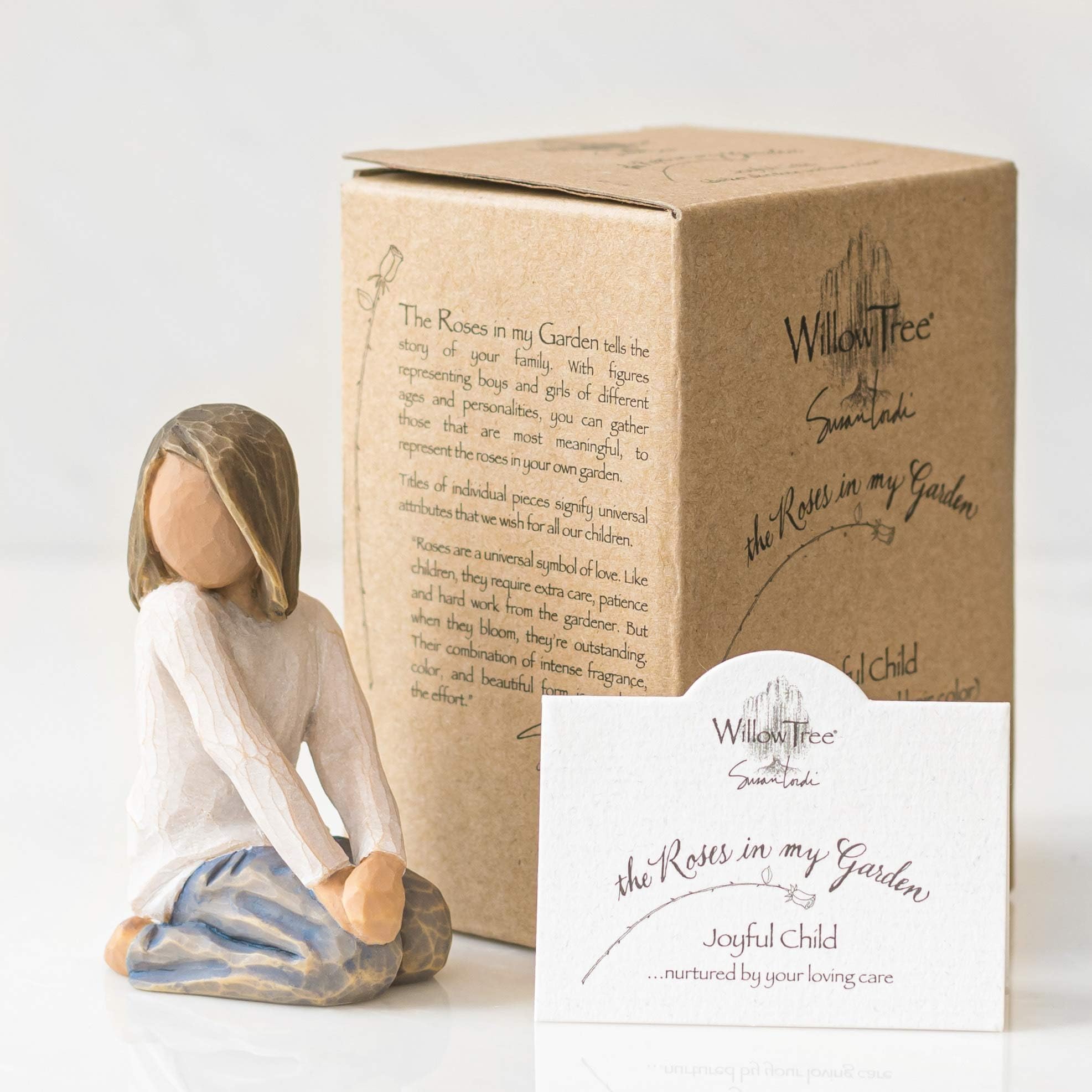 Willow Tree joyful child next to a ruler for scale, clarifying compact display size benefit