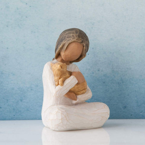 Willow Tree figure beside a book showing 3-inch scale and display versatility