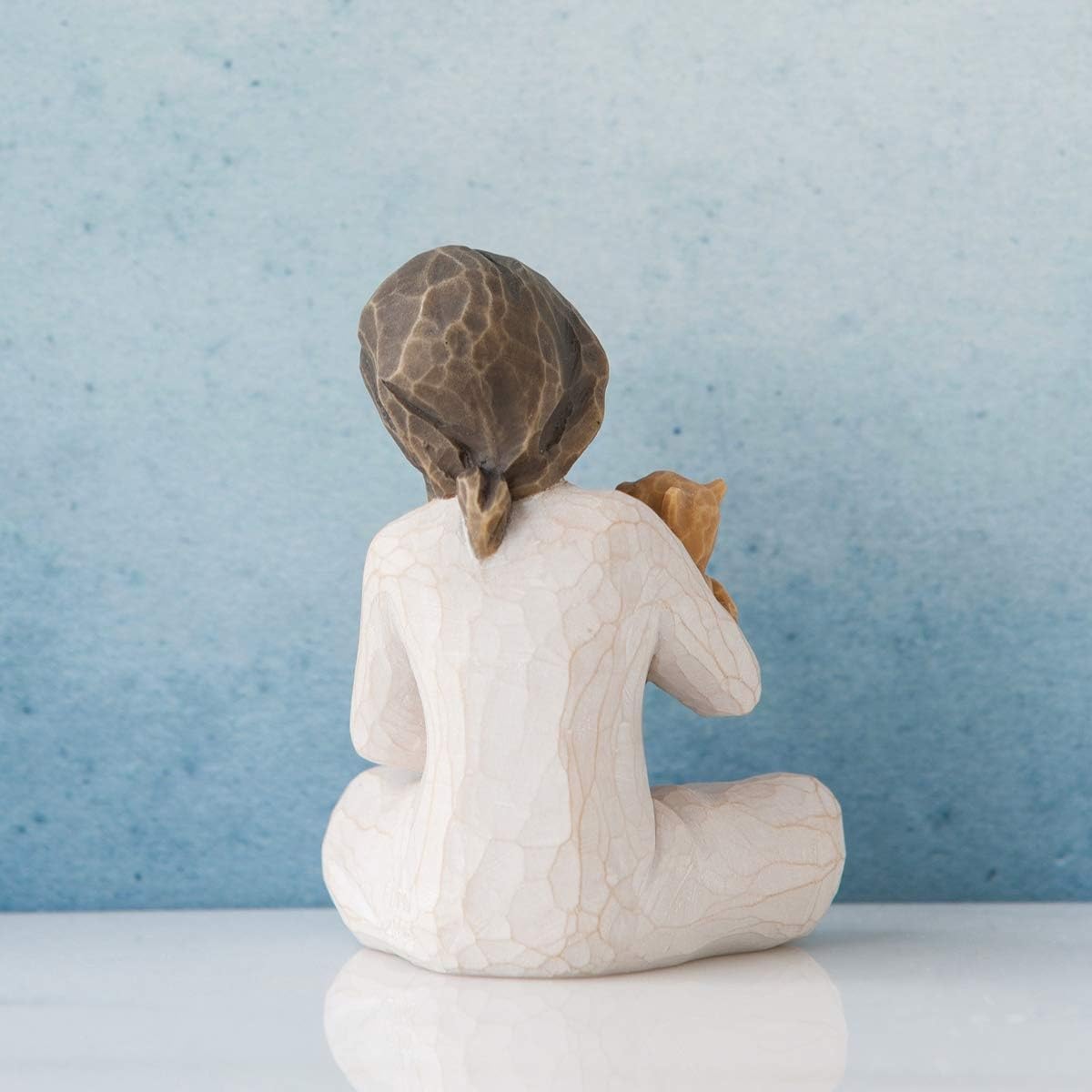 Willow Tree side profile of seated girl showing dress folds and calming pose