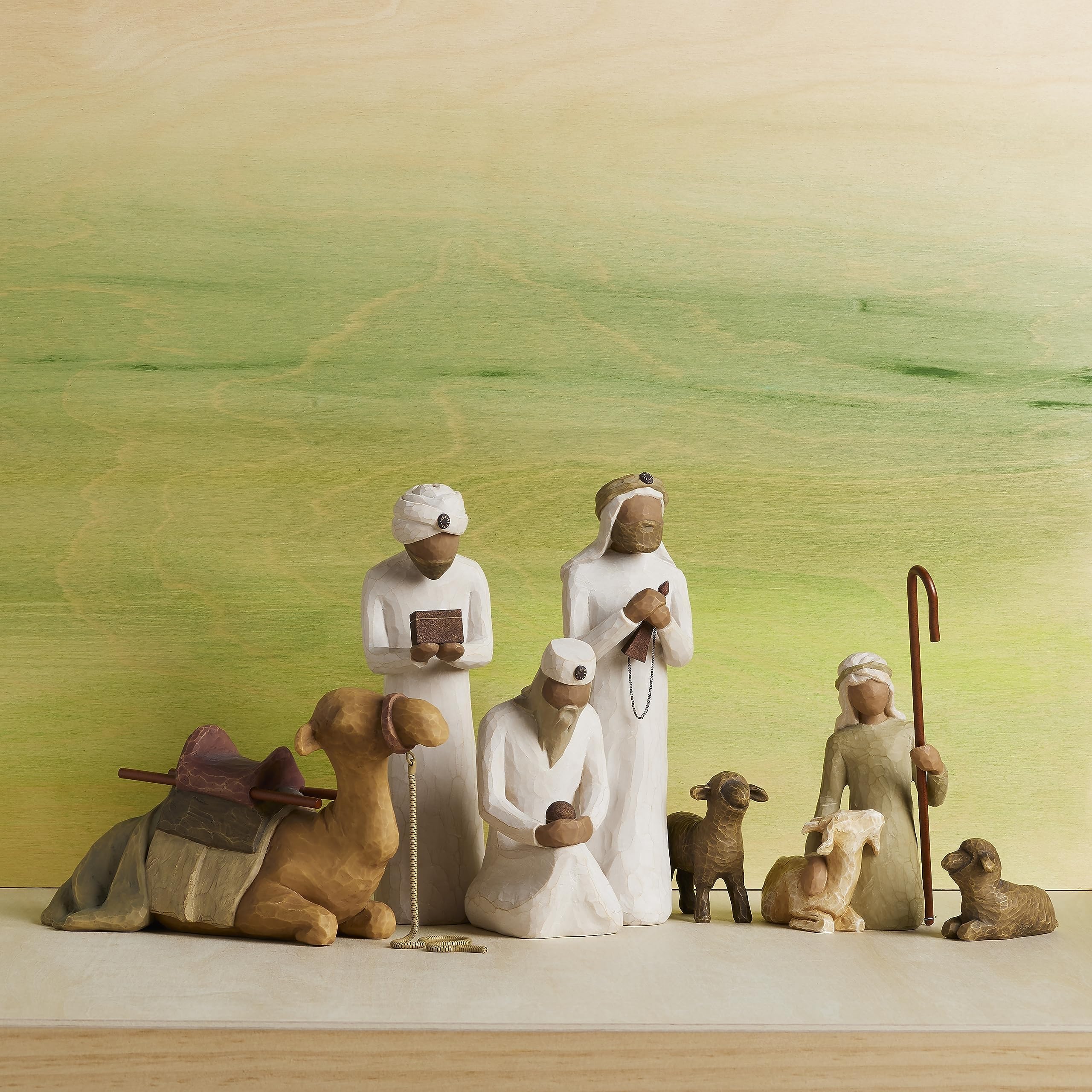 Willow Tree nativity on mantel styled with greenery for peaceful holiday display