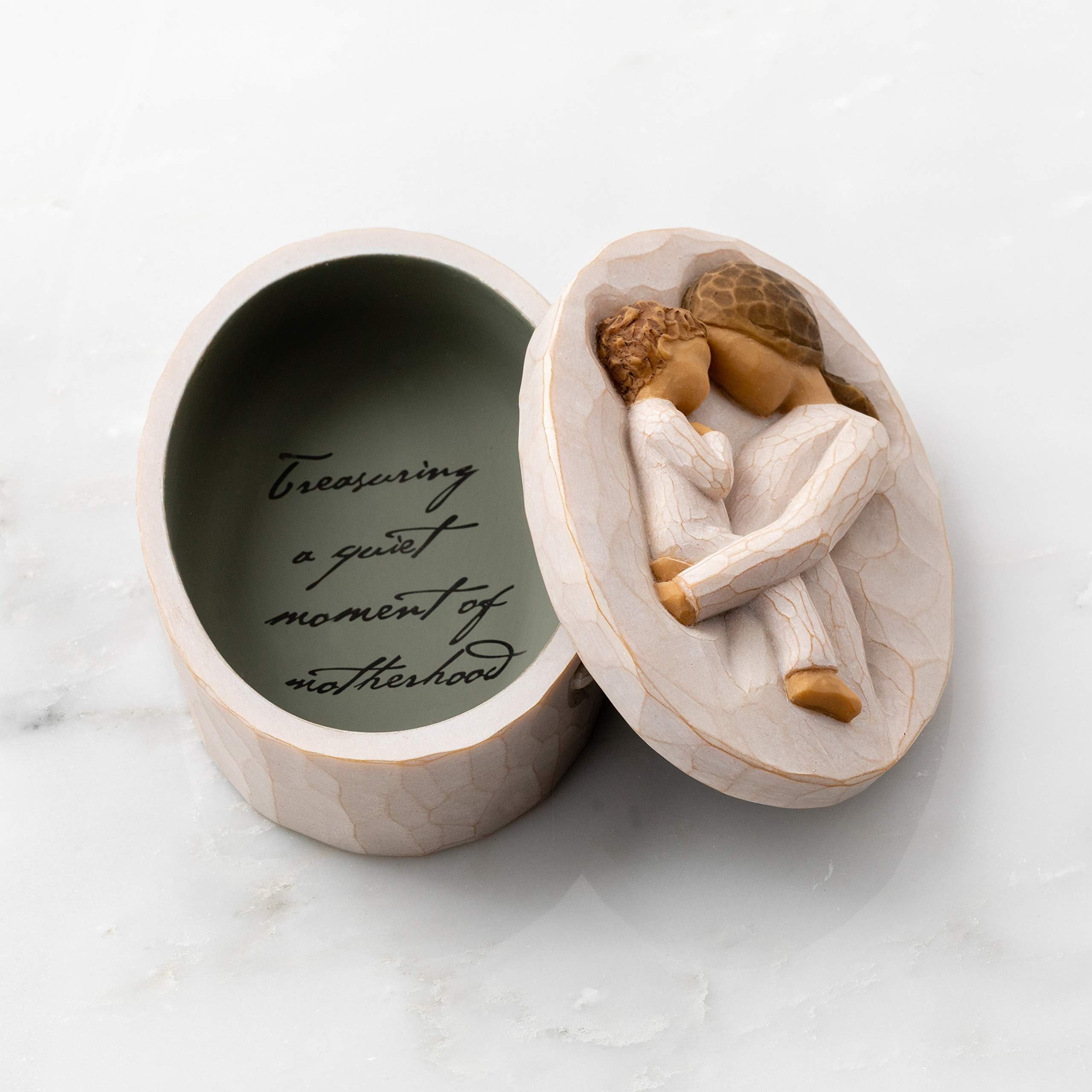 Willow Tree keepsake box displayed on a mantel with flowers, suggests thoughtful decor