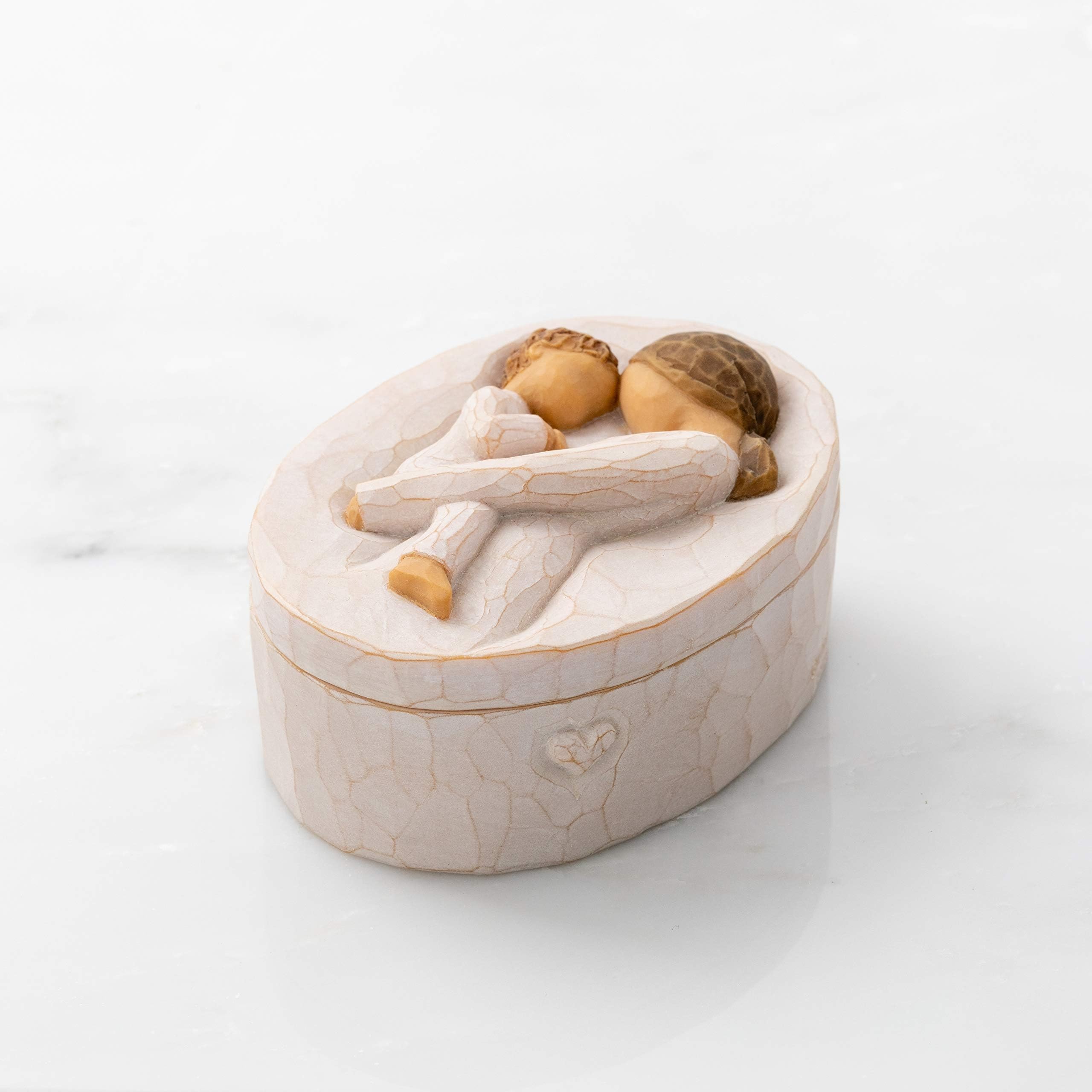 Willow Tree size comparison next to a hand, shows compact dimensions and gift suitability