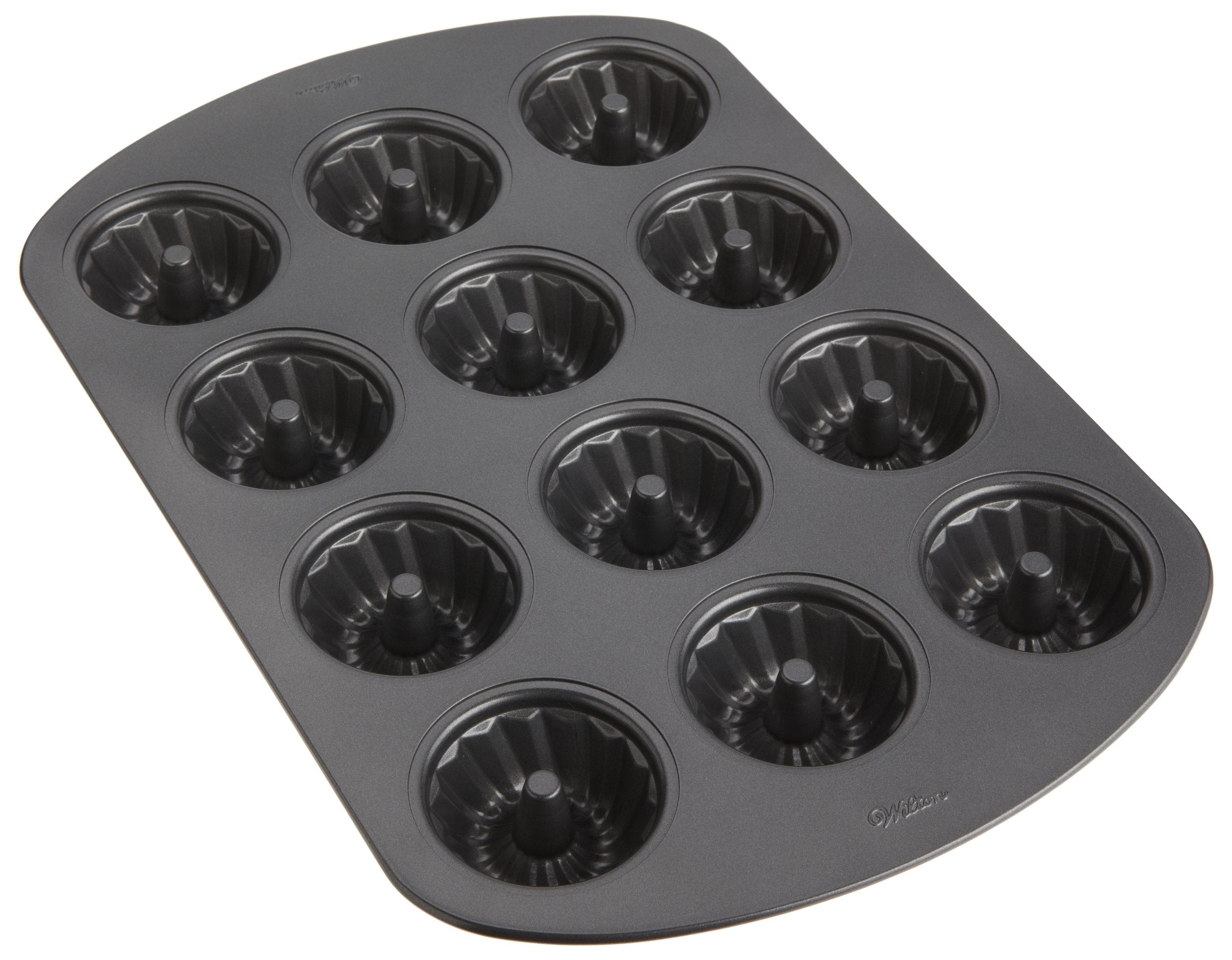 Wilton pan filled with baked mini fluted cakes demonstrating clean release