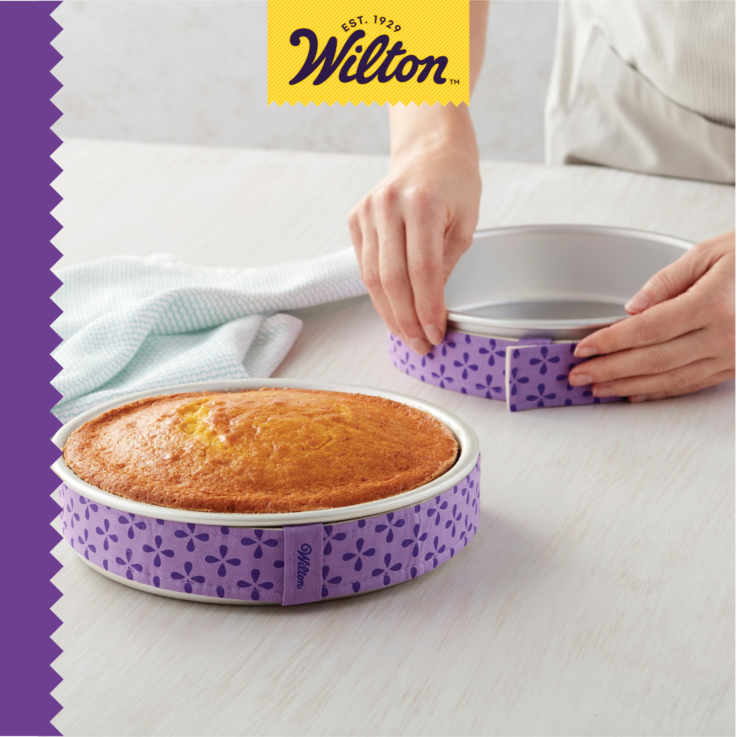 Wilton in kitchen with stacked cakes showing consistent layers benefit