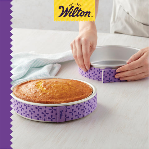 Wilton in kitchen with stacked cakes showing consistent layers benefit