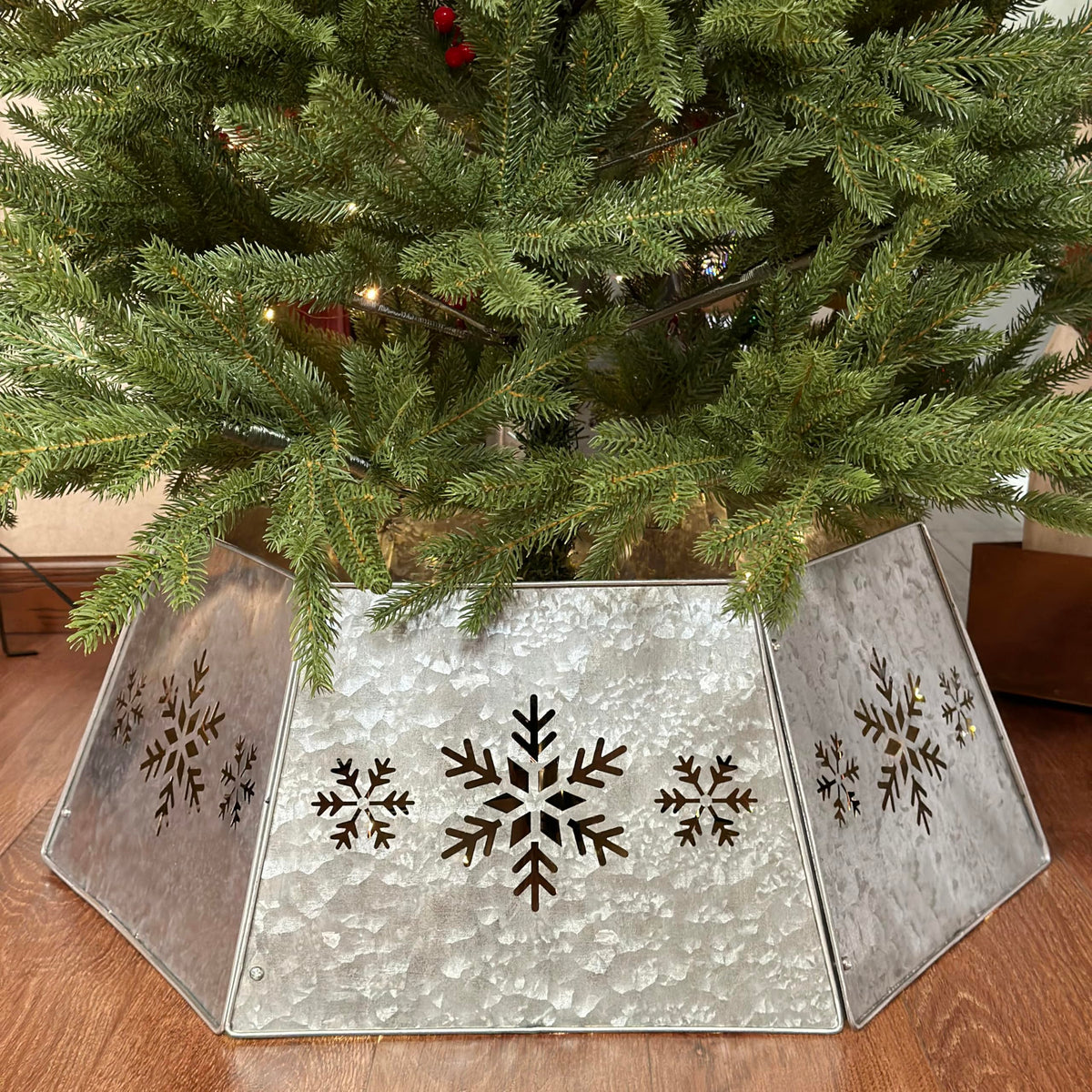 WKHOMEDECO front view of galvanized tree collar showing full snowflake design and tidy base concealment