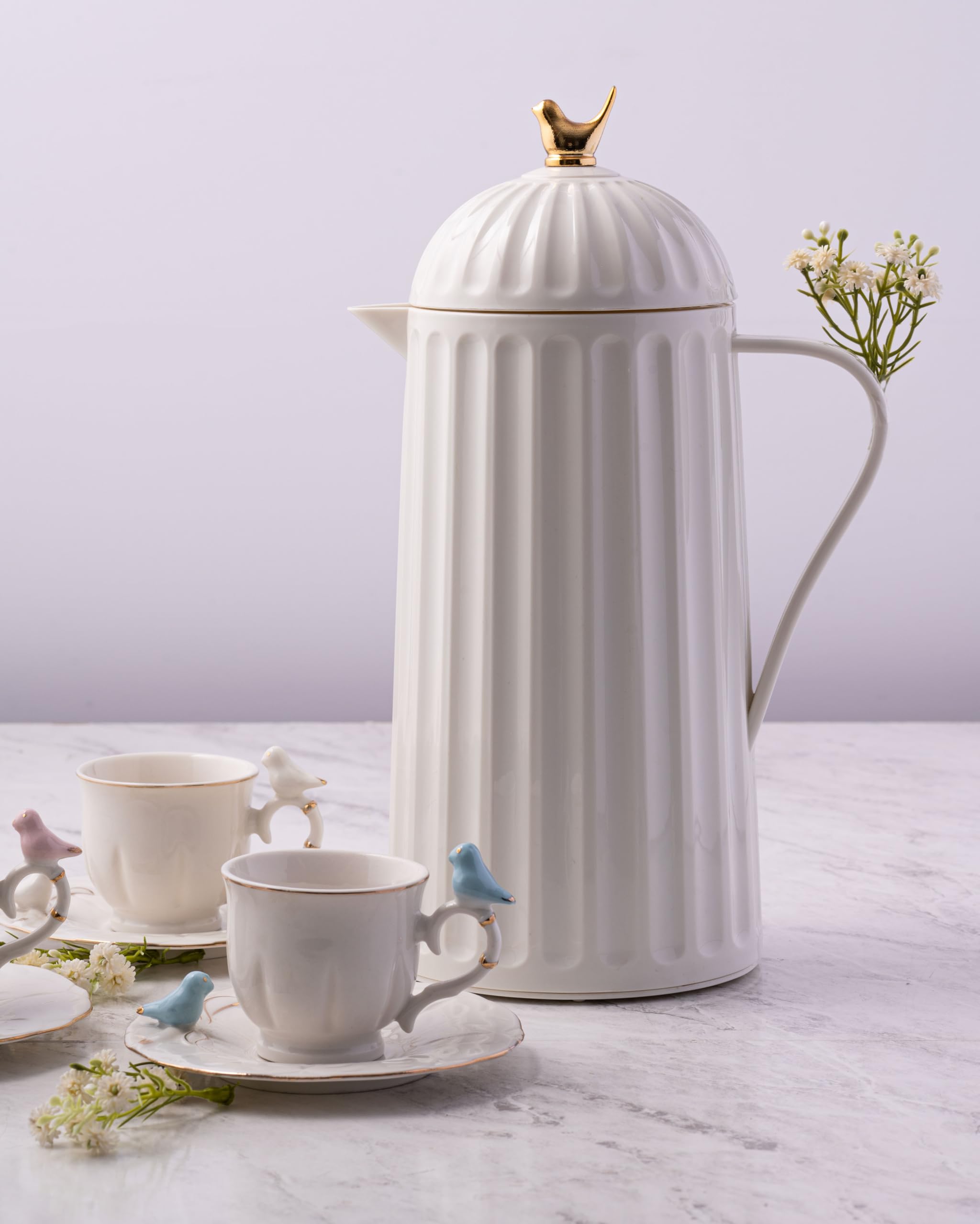 WOLFF beside a cup for scale showing 1L capacity and compact size