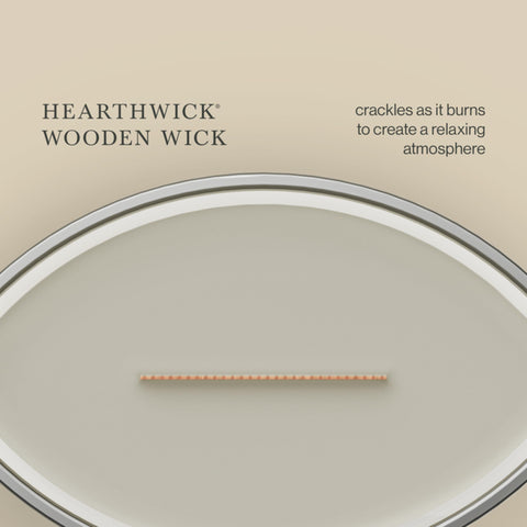 WoodWick candle staged in living room creating cozy, inviting atmosphere