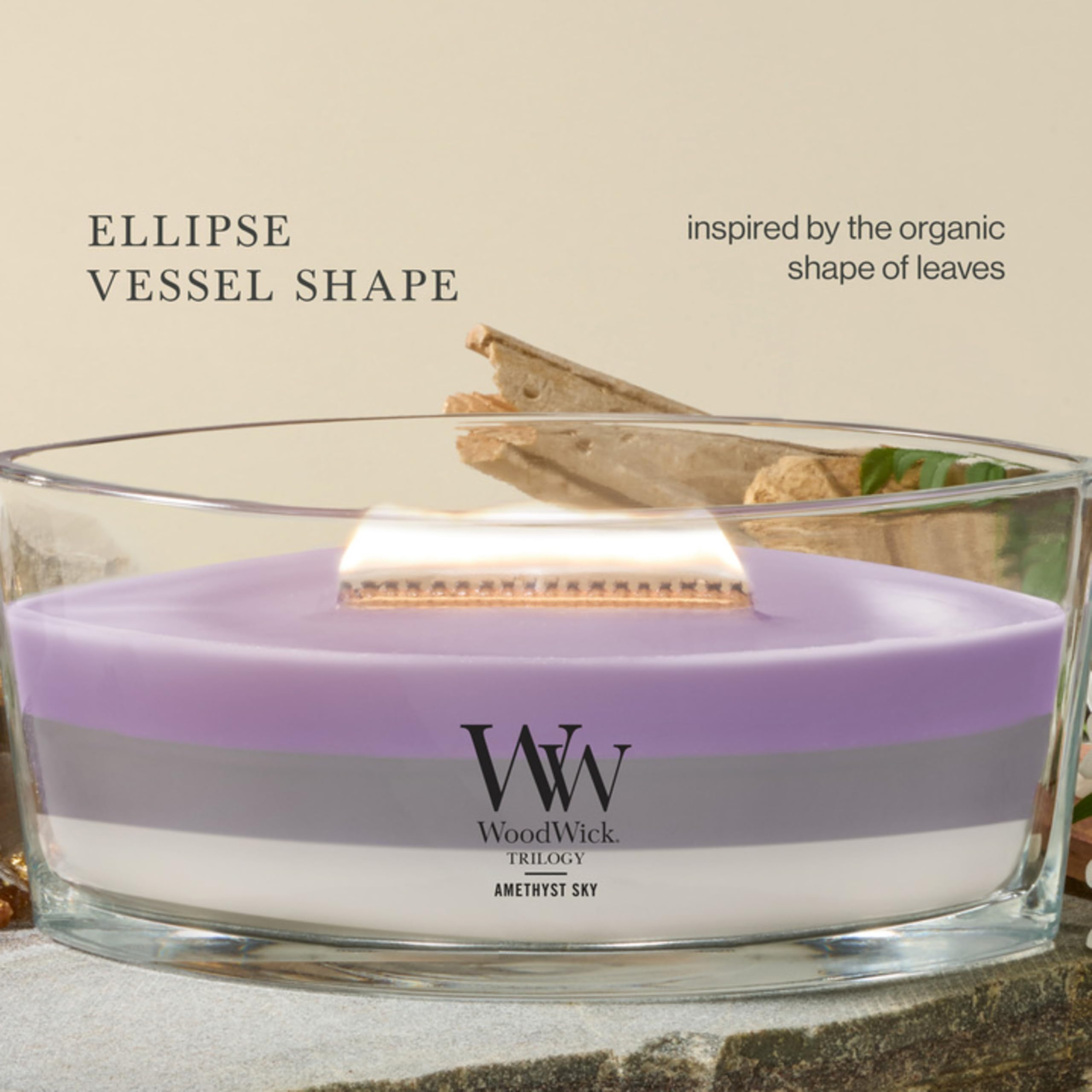 WoodWick candle lit in living room showing warm ambiance and multi-room fragrance benefit