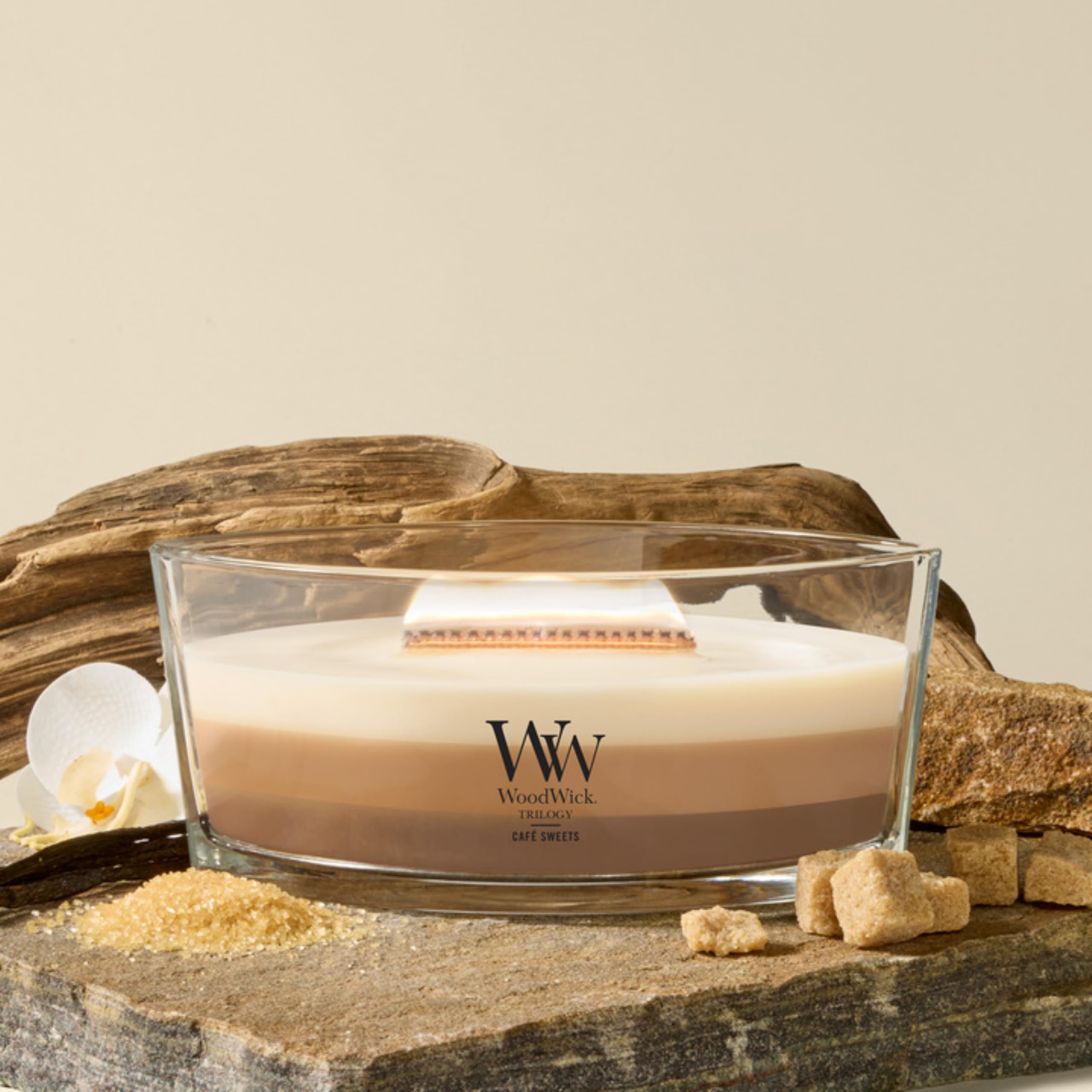 WoodWick lit candle flame with cozy crackle creating warm ambiance