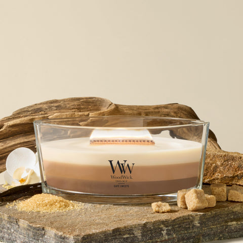 WoodWick lit candle flame with cozy crackle creating warm ambiance
