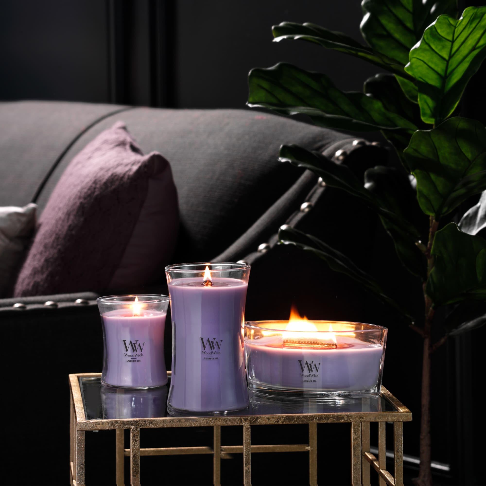 WoodWick candle staged in bathroom creating spa-like atmosphere and relaxation benefit