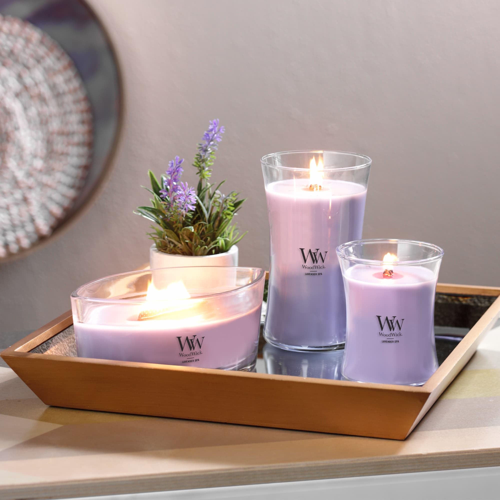 WoodWick lit candle with visible crackling wick providing cozy sound and calming benefit