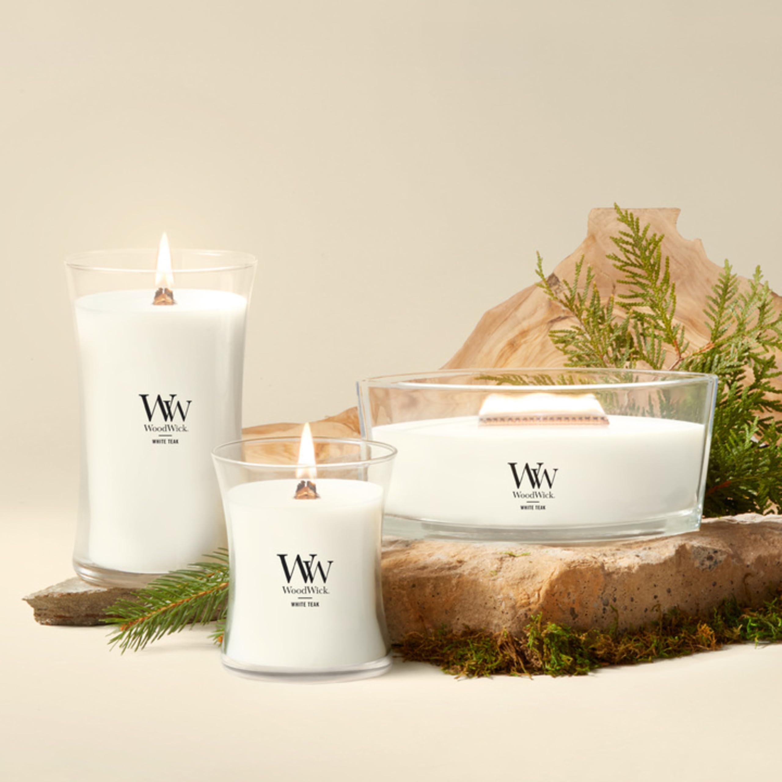 WoodWick(ウッドウィック) lit candle at dusk creating warm, crackling hearthlike ambiance