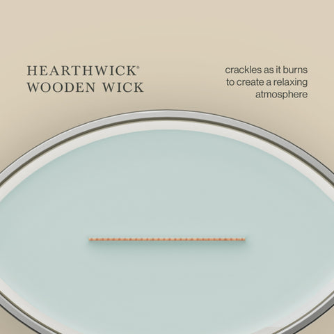 WoodWick candle in a styled living room creating calm scent and warm lighting