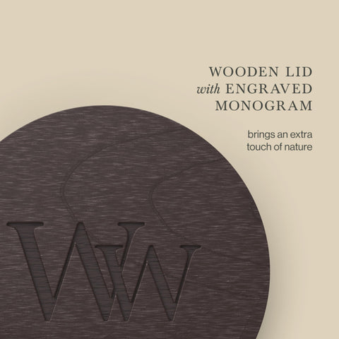 WoodWick candle on cozy living room table setting creating relaxed ambiance