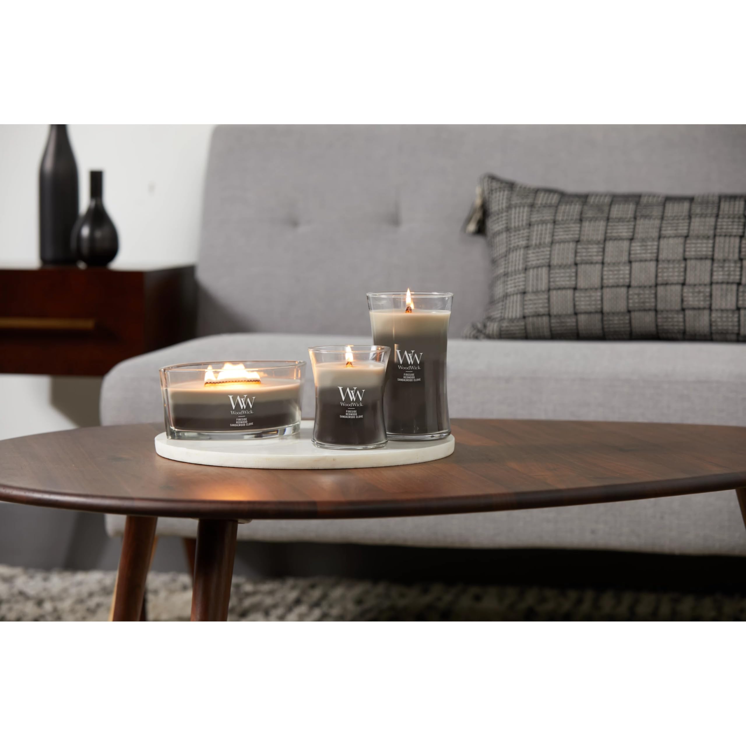 WoodWick candle staged in living room creating warm atmosphere and fragrance